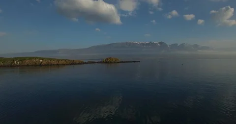 Flying over clear water with mountains in background - Iceland 스톡 동영상 105214948
