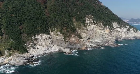 Flying over the cliff and coast of the Taejongdae scenic spot in Busan Stock Footage 100968212