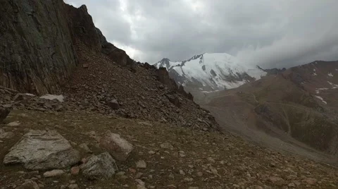 Flying over the cliff. Lovely view of the glacier in the rainy weather. Stock Footage 68451226