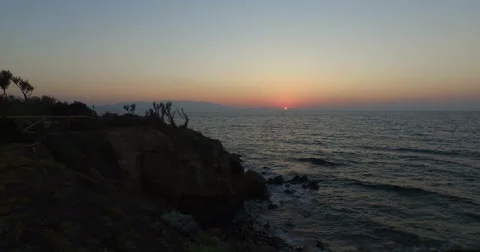 Flying over cliff to sunset. Video stock 60693390