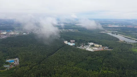 Flying over the cloud over the suburb of a large city, the view from the drone 스톡 동영상 113930587