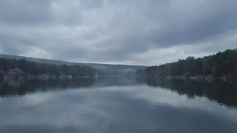 Flying Over Cloud Reflections On Small Lake Stock Footage 95562140