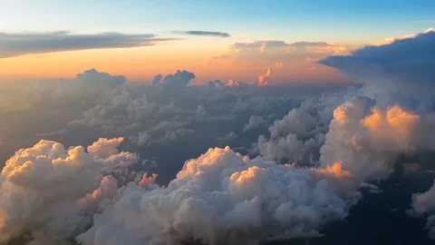 Flying over clouds at 30,000 feet at sunset Stock Footage 92646287