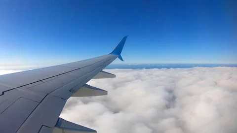 Flying over clouds amid the blue sky on the plane. Video stock 129737206