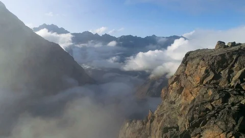 Flying over the clouds and mountain peaks Stock Footage 121745583