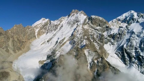 Flying over the clouds and mountain peaks Stock Footage 121745612