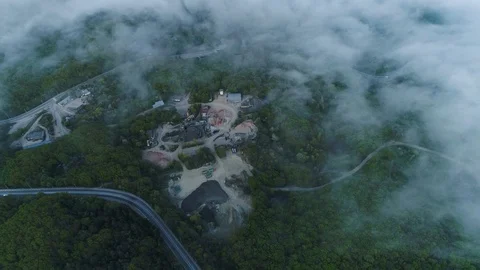 Flying over Clouds and a Road with Buildings Visible Through them.Top View. Crim Stock Footage 126267489
