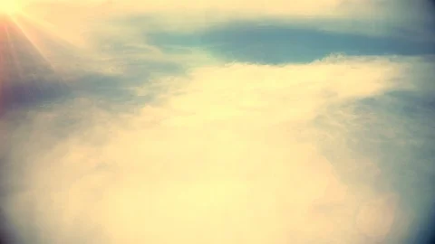 Flying Over The Clouds With Beautiful Lens Flare, Seamlessly Looped Stock Footage 103084118