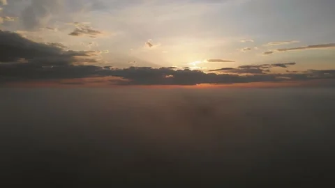 Flying over the clouds. Beautiful sunrise or sunset over the clouds. Orange sky Stock Footage 160931533