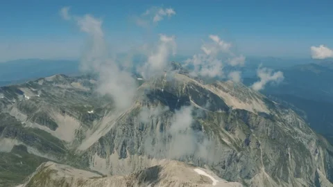 Flying over the clouds of Corno Grande, Gran Sasso Abruzzo Italy 4K Stock Footage 210426451