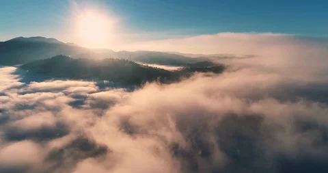 Flying over the clouds during morning sunrise 動画素材 128695378