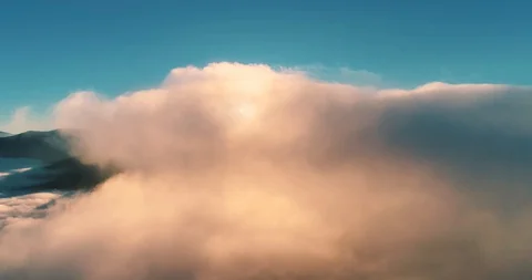 Flying over the clouds during morning sunrise Stock Footage 128695397