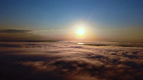 Flying over the clouds during morning sunrise Stock Footage 129894011