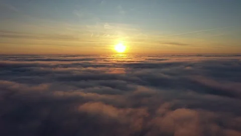 Flying over the clouds during sunset Stock Footage 126965457