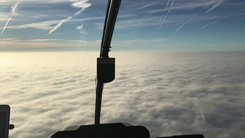 Flying over clouds, helicopter cockpit view Видео 74060191