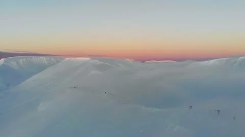 Flying over the clouds in the mountains. Aerial view. Colorful winter sunset in 스톡 동영상 152587767