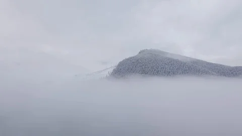 Flying over the clouds in the mountains Stock Footage 129699691