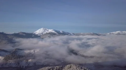 Flying over the clouds in the mountains in winter Stock-Footage 129599701