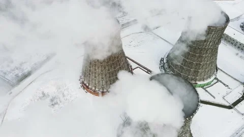 Flying over clouds of steam emitted by the power plant. Three towers emit carbon Stock Footage 145715719