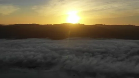 Flying over the clouds at sunrise Stock Footage 262503308