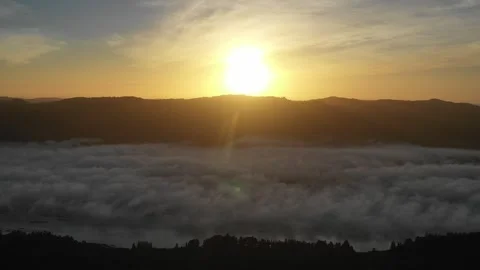 Flying over the clouds at sunrise Stock Footage 262503498