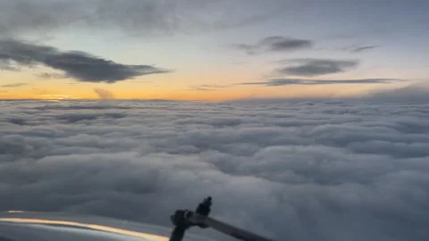 Flying over clouds at sunset Stock Footage 296840412