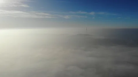 Flying over clouds. Video shot by drone in early morning. Smog above city. Look Stock Footage 123435077