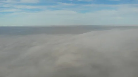 Flying over clouds. Video shot by drone in early morning. Smog above city. Look Stock Footage 123610467