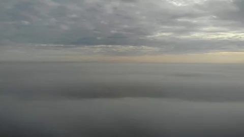 Flying over clouds. Video shot by drone in early morning. Smog above city Stock Footage 123610623