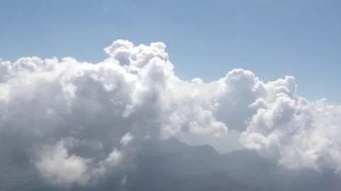 Flying over the clouds, view from the plane on a blue sky and cumulus clouds. Stock Footage 120539245