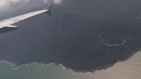 Flying over the clouds, view from the plane on a blue sky and cumulus clouds. Video stock 120539893