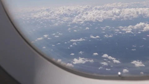 Flying over the clouds, view from the plane on a blue sky and cumulus clouds. Stock Footage 120540029