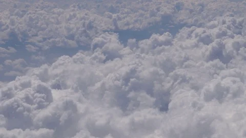 Flying over the clouds, view from the plane on a blue sky and cumulus clouds. Stock Footage 120540044