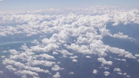 Flying over the clouds, view from the plane on a blue sky and cumulus clouds. Stock Footage 120540062
