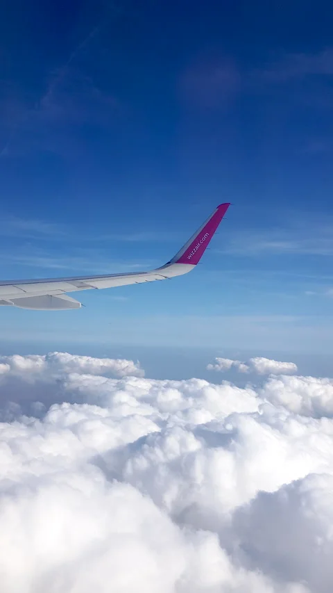 Flying over the clouds. View from plane aircraft passenger window with clouds Stock Footage 134624459
