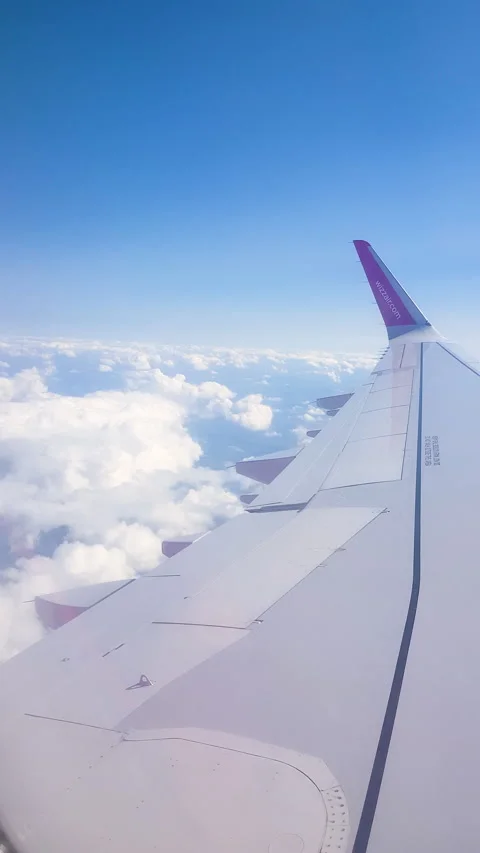 Flying over the clouds. View from plane aircraft passenger window with clouds Stock Footage 134624488