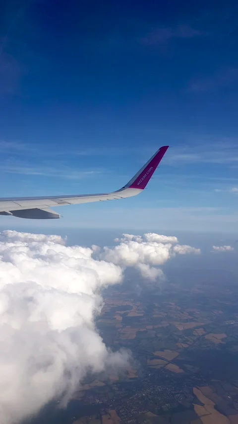 Flying over the clouds. View from plane aircraft passenger window with clouds Stock Footage 134624732