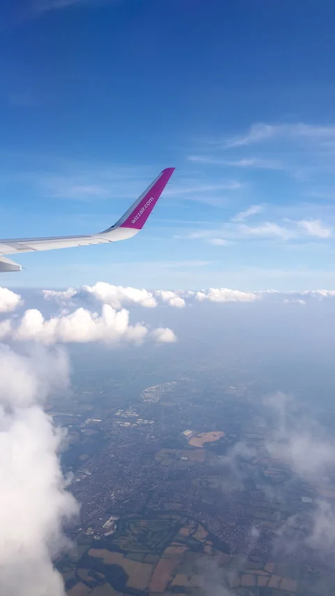 Flying over the clouds. View from plane aircraft passenger window with clouds Stock Footage 134624894