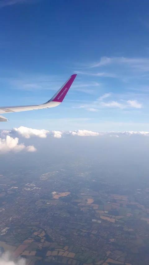 Flying over the clouds. View from plane aircraft passenger window with clouds Stock Footage 134624916