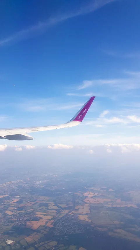 Flying over the clouds. View from plane aircraft passenger window with clouds Stock Footage 134625339