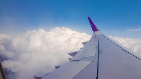 Flying over the clouds. View from plane aircraft passenger window with clouds Stock Footage 138582347