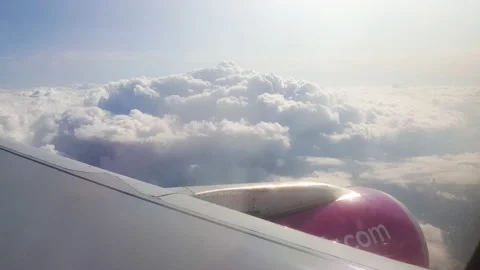 Flying over the clouds. View from plane aircraft passenger window with clouds Stock Footage 138582983