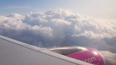 Flying over the clouds. View from plane aircraft passenger window with clouds Stock Footage 138583081