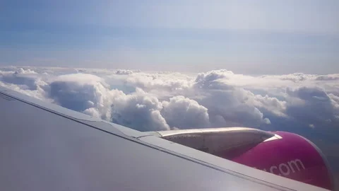 Flying over the clouds. View from plane aircraft passenger window with clouds Stock Footage 138584195