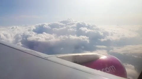 Flying over the clouds. View from plane aircraft passenger window with clouds Fotos de archivo