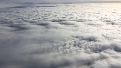 Flying over clouds viewed from passenger jet 4K Stock Footage 83100572