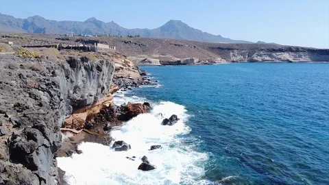 Flying Over Coast And Waves, Reverse Aerial Shot Stock Footage 124929811