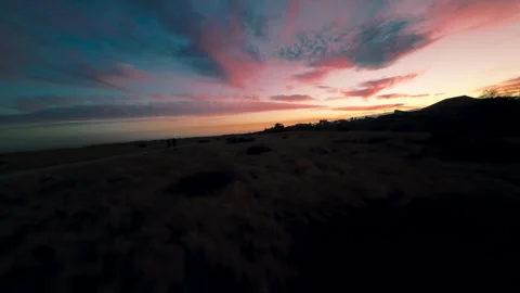 Flying over a coast with a beautiful sunset sky Stock Footage 280964513