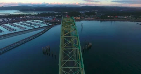 Flying over a coastal bridge at sunset (Newport, OR) Stock Footage 67647543