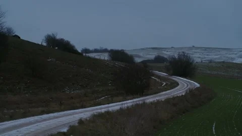 Flying over cold, snowy, winter landscape at dusk, drone stock footage 6 Stock Footage 140032951